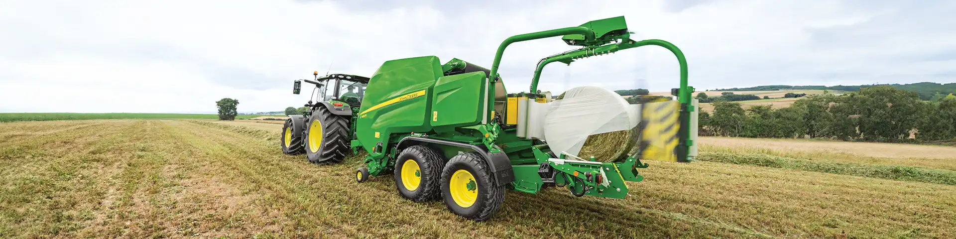 Banner JD stretchfilm baler working in the field